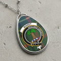 Bisset clan Scottish tartan necklace with clan crest and Abscissa Virescit motto on tartan background