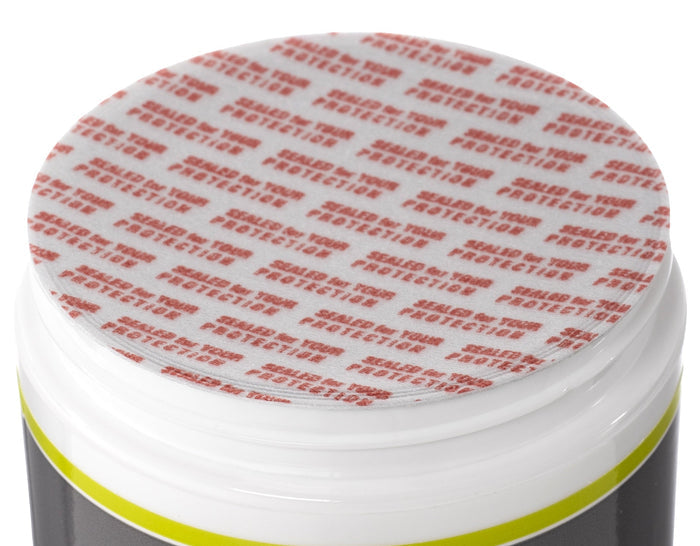 Jar with a safety seal featuring red text on a white background