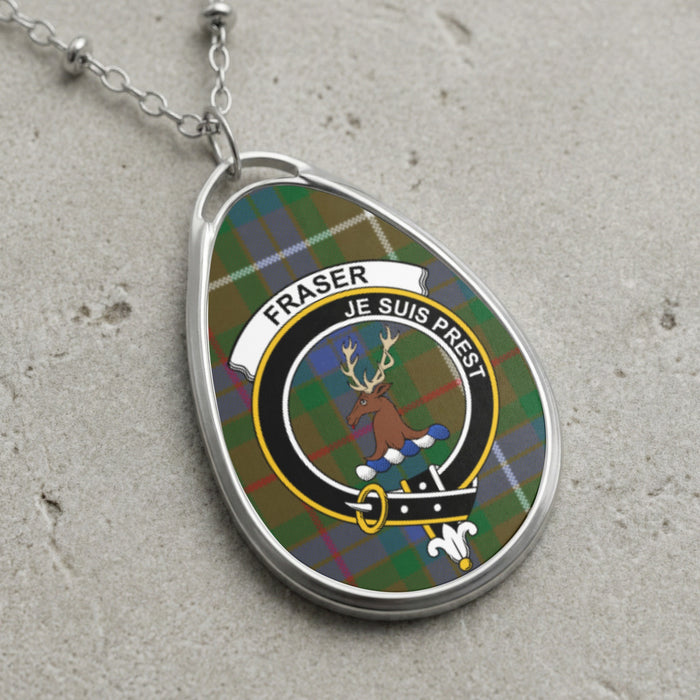 Fraser clan Scottish tartan necklace with clan crest and Je Suis Prest motto on tartan background