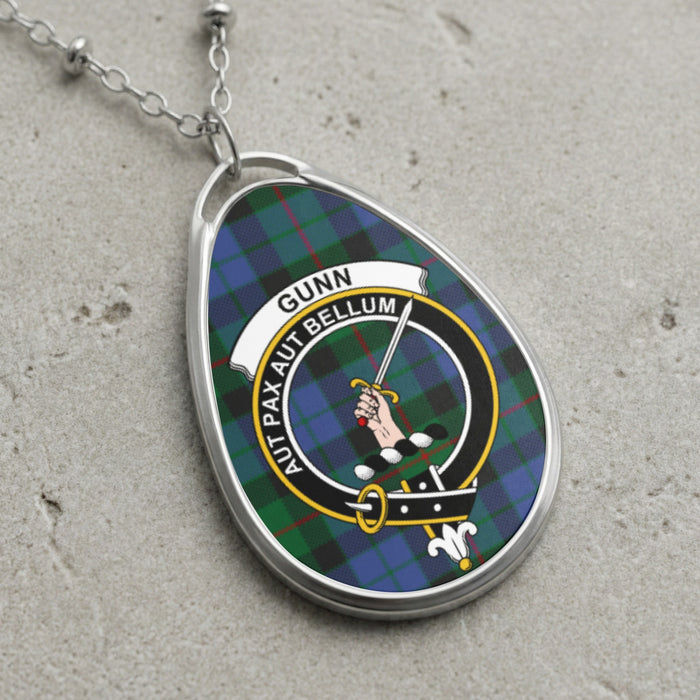 Gunn clan Scottish tartan necklace with clan crest and Aut Pax Aut Bellum motto on tartan background