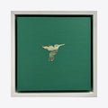 The artwork 'Profit Margins, Hummingbird' by Jacki Davis features a delicate hummingbird silhouette crafted from US currency against a rich emerald green background. The mixed media piece combines acrylic paint on wood panel with intricately cut paper money, creating a minimalist yet striking 8x8 inch composition framed in silver.