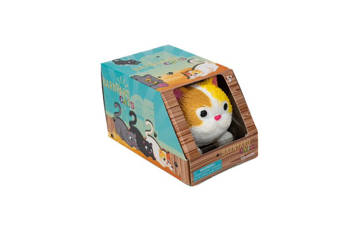 A plush toy cat with white and orange fur is displayed in a colorful, open-front Barnyard Cats box from Farm Fresh, decorated with cartoon cats and barnyard-themed graphics for imaginative play.